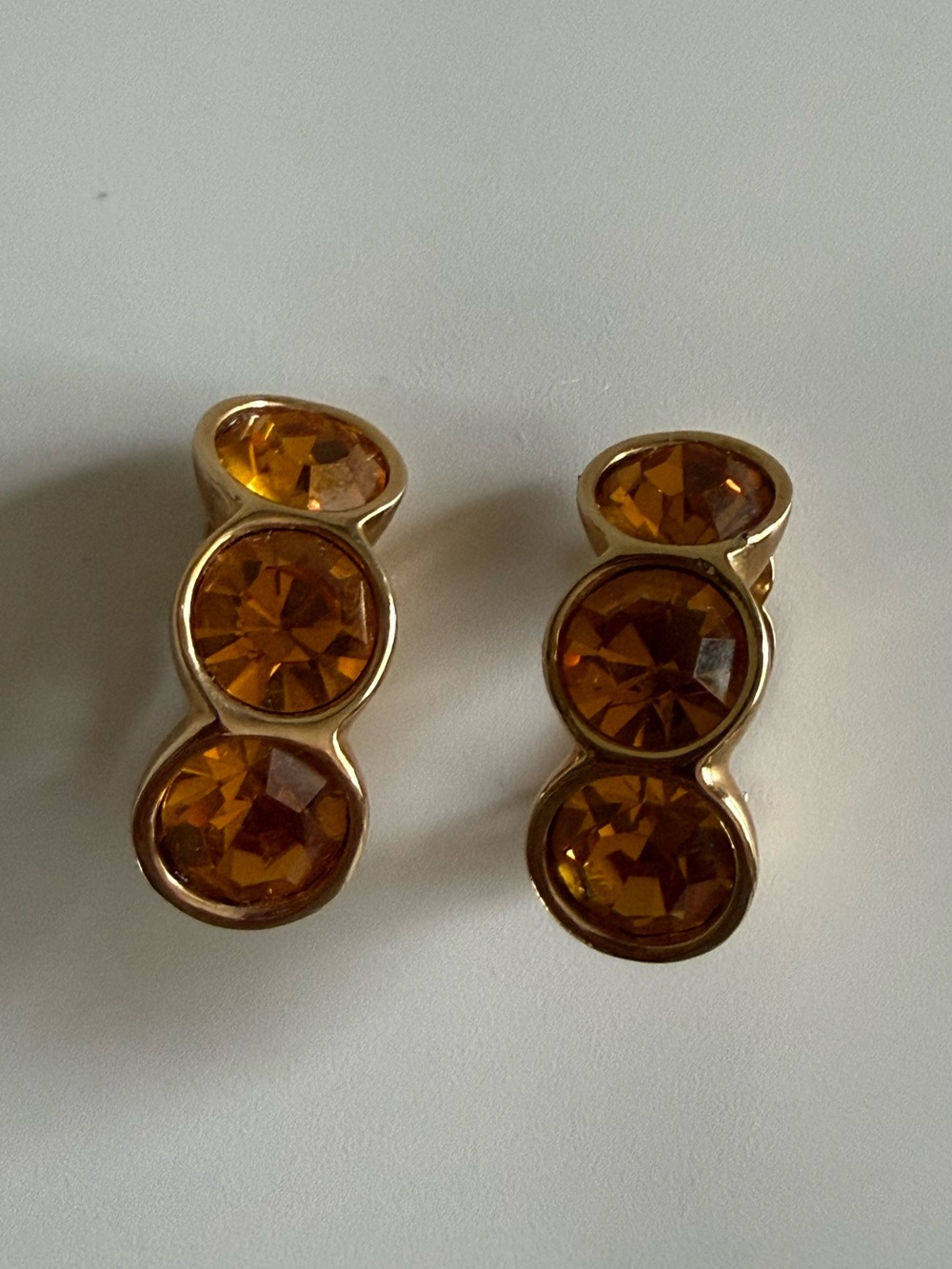 Vintage Swarovski S.A.L. gold-tone clip-on earrings featuring amber crystals